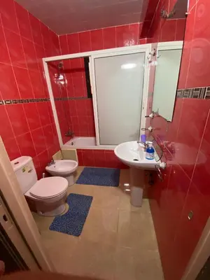 a red bathroom with a toilet and a sink at Marrakech gliz in Marrakech