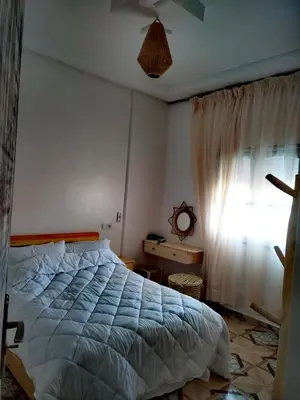 a bedroom with a bed and a window at الراحة والسلامة مراكش in El Gouassem