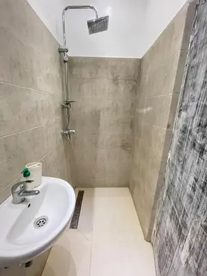 a bathroom with a sink and a shower at Modern et calme a Marrakech in Marrakech