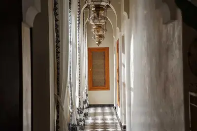 a hallway with white curtains and a window at Daba Riads in Marrakech