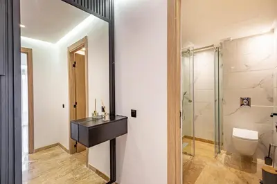 a bathroom with a toilet and a glass shower at Studio Ali gueliz in Marrakech