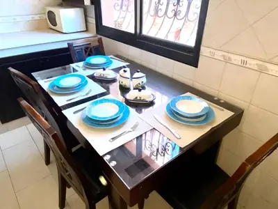 a table with blue and white dishes on it at Luxury apartment in Gueliz, near the Majorelle Garden and Yves Saint Laurent Museum in Marrakech