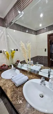 a bathroom with two sinks and a large mirror at Luxury apartment in Gueliz, near the Majorelle Garden and Yves Saint Laurent Museum in Marrakech