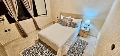 a small bedroom with a bed in a room at Luxury apartment in Gueliz, near the Majorelle Garden and Yves Saint Laurent Museum in Marrakech