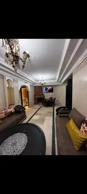 a large living room with couches and a table at Riad jawhara in Marrakech