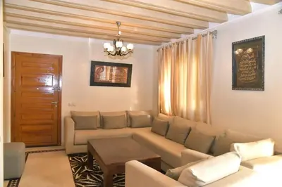 a living room with a couch and a table at Ideal family apartment in Marrakech