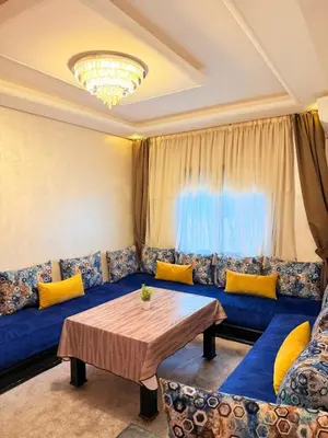 a living room with a blue couch and yellow pillows at Appartement N15 Lumineux Calme & Centre-ville in Marrakech