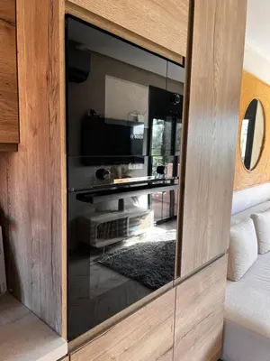 a large glass cabinet with a television in it at Your Getaway Oasis in the Lush Resort in Marrakech
