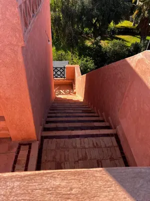 a set of stairs leading up to a building at Your Getaway Oasis in the Lush Resort in Marrakech