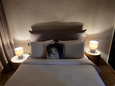 a bedroom with a bed with a clown pillow on it at Your Getaway Oasis in the Lush Resort in Marrakech