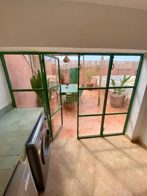 a living room with glass doors and a patio at Riad Les 3J in Marrakech