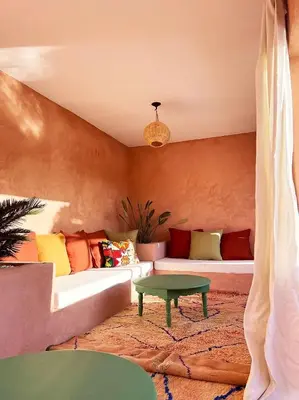 a living room with a couch and a table at Riad Les 3J in Marrakech