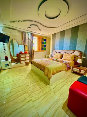 a bedroom with a large bed and a mirror at المحاميد 10 in Marrakech