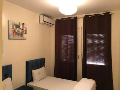 a room with a bed and a black curtain at Appartement Simouni in Marrakech