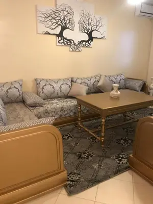 a living room with a couch and a table at Appartement Simouni in Marrakech
