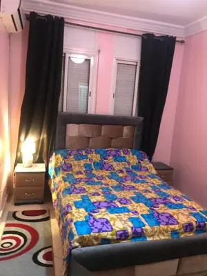 a bedroom with a bed with a colorful quilt on it at Appartement Simouni in Marrakech