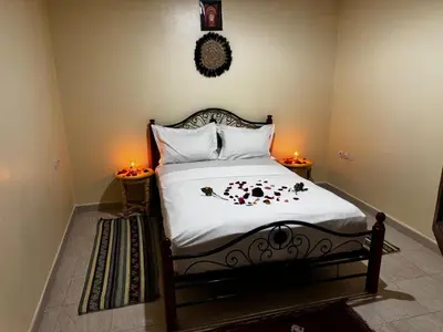 a bedroom with a bed with flowers on it at Riad dar Malak in Marrakech