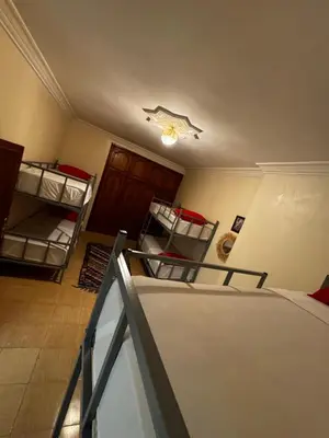 a room with two bunk beds and a ceiling at Riad dar Malak in Marrakech