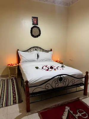 a bedroom with a bed with flowers on it at Riad dar Malak in Marrakech