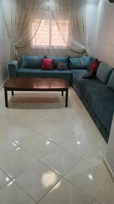 a living room with a couch and a coffee table at Mountazah al jadid H22 in Marrakech