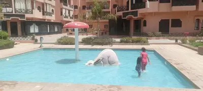 a pool with a polar bear in the water at Premium village A644 in Marrakech
