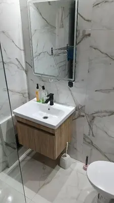 a white bathroom with a sink and a mirror at Premium village A644 in Marrakech