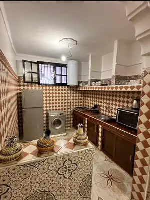 a kitchen with a stove and a refrigerator in a room at Apartment in heart of Medina in Marrakech