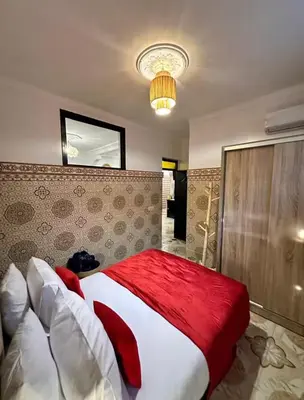 a bedroom with a large bed with a red blanket at Apartment in heart of Medina in Marrakech