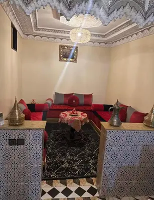 a living room with a red couch and a table at Apartment in heart of Medina in Marrakech