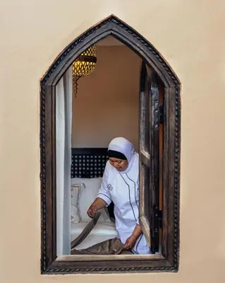 a man looking out of a window with a bat at Riad Privatif avec Personnel et Services Exclusifs - Kasbah Boma Marrakech I in Marrakech