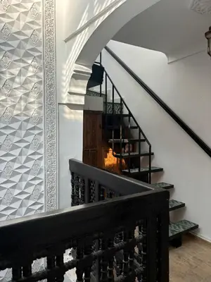 a spiral staircase in a house with a stair railing at Riad bab Adam in Marrakech