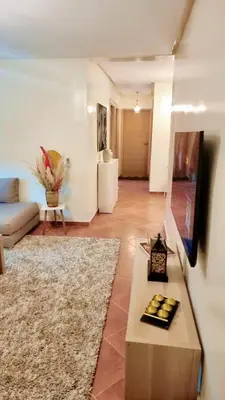 a living room with a couch and a table at Immob in Marrakech
