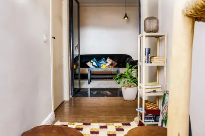 a living room with a couch and a table at Cozy & Bright Apartment with a Panoramic View in Marrakech