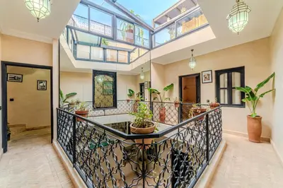an open hallway with a balcony with potted plants at Riad Dar Davia - Jacuzzi Rooftop - Breakfast in Marrakech