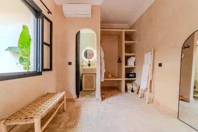 a hallway with a bench and a window at Riad Dar Davia - Jacuzzi Rooftop - Breakfast in Marrakech