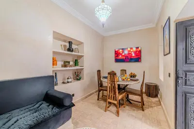 a living room with a couch and a table at Riad Dar Davia - Jacuzzi Rooftop - Breakfast in Marrakech