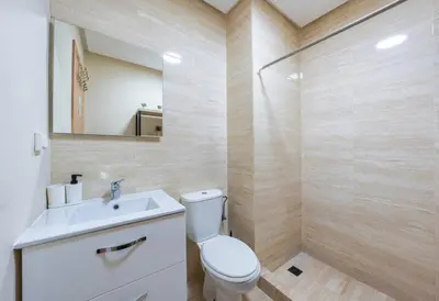 a bathroom with a toilet and a sink and a mirror at Trois chambres et Jardin Prive a Prestigia in Marrakech