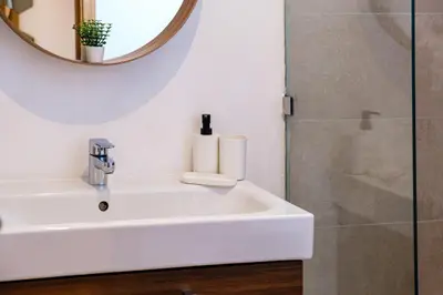 a bathroom with a white sink and a mirror at Luxury and Serenity at Noria Golf and Pool in Marrakech