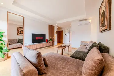 a living room with a couch and a tv at Luxury and Serenity at Noria Golf and Pool in Marrakech