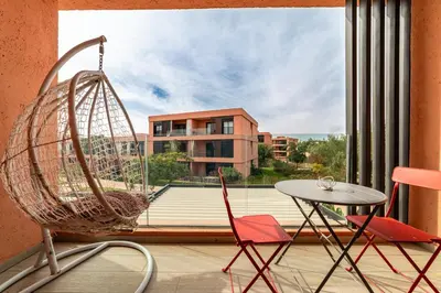 a room with a swing and a table and a window at Luxury and Serenity at Noria Golf and Pool in Marrakech