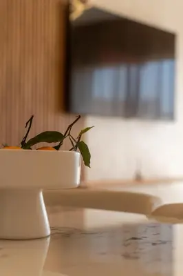a plant in a white bowl on a table at Orange apartment in Marrakech