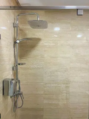 a shower with a shower head in a bathroom at Orange apartment in Marrakech