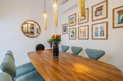 a dining room with a wooden table and chairs at Riad Dar Catalia-Exclusive&HeatedPool-FreeBreakfas in Marrakech