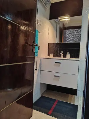 a bathroom with a shower and a sink and a door at Séjour Familial à Marrakech in Marrakech