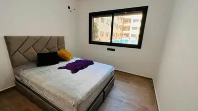 a small bedroom with a bed with a window at Luxury apartment in Gueliz Marrakech in Marrakech
