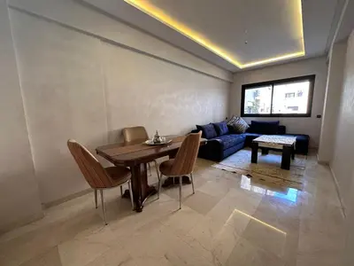 a living room with a table and a couch at Luxury apartment in Gueliz Marrakech in Marrakech