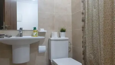 a bathroom with a toilet and a sink and a shower at Luxury apartment in Gueliz Marrakech in Marrakech