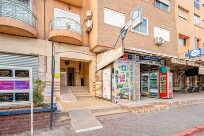 a store on a street in front of a building at Le stratégique a 10mn de l'aéroport face gare Ctm Hivernage in Marrakech
