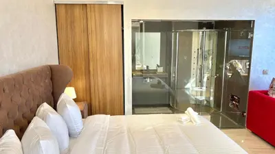 a bedroom with a shower and a bed in it at Villa de rêve avec Piscine privée & Petit-déj gratuit in Ouled Rahou