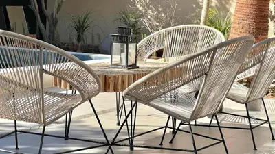 a group of three chairs sitting around a table at Villa de rêve avec Piscine privée & Petit-déj gratuit in Ouled Rahou